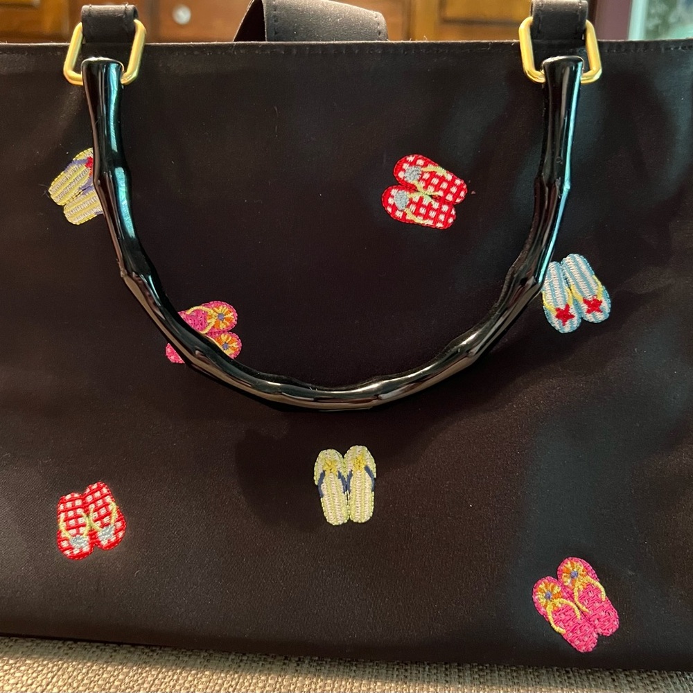 Tiannl purse with flip flops all around